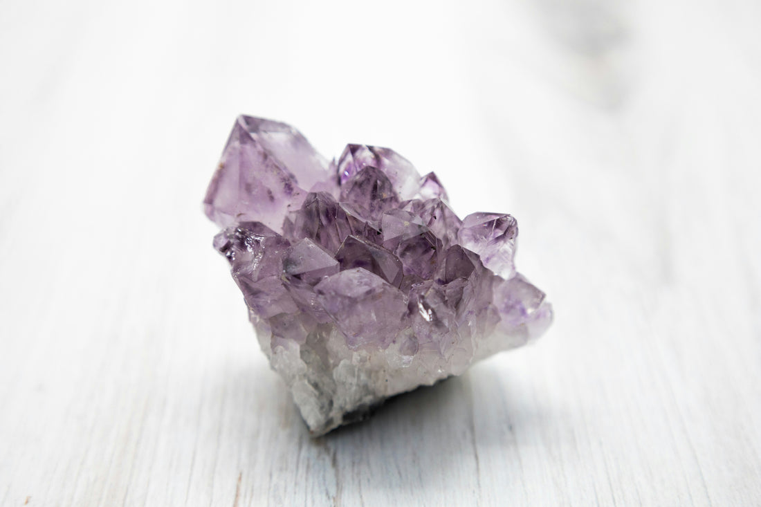 Purple Amethyst crystal has a transparent and unusual crystalline structure. Under natural light, the crystal is smooth and reflective. This image shows Amethyst's inherent beauty, perfect for décor, spirituality, and mineral collections.